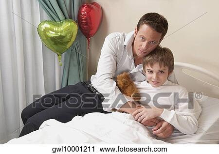 Father with his son in a hospital View Large Photo Image Stock Image - Father with his son in a hospital. Fotosearch