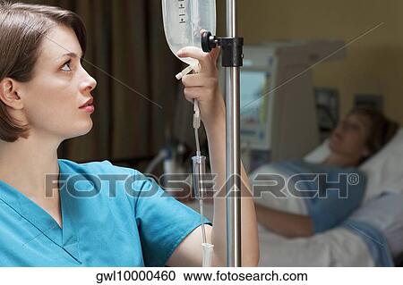 Female doctor checking a saline drip View Large Photo Image Stock Image - Female doctor checking a saline drip. Fotosearch