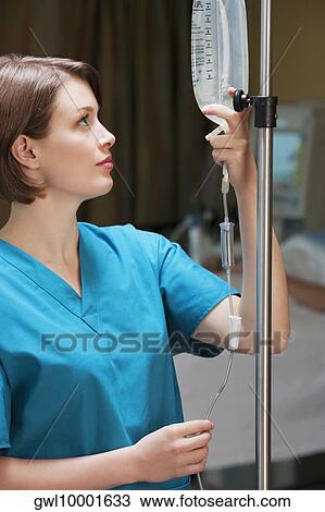 Female doctor checking a saline drip View Large Photo Image Stock Image - Female doctor checking a saline drip. Fotosearch