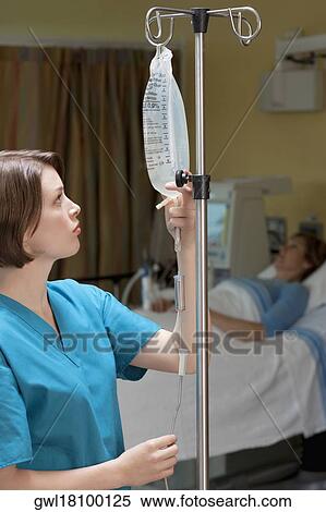 Female doctor checking a saline drip View Large Photo Image Stock Photography - Female doctor checking a saline drip. Fotosearch