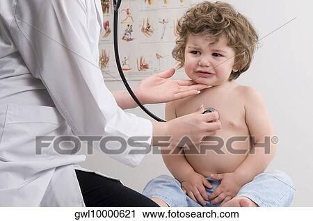 Female doctor examining a baby boy with a stethoscope View Large Photo Image Stock Image - Female doctor examining a baby boy with a stethoscope. Fotosearch
