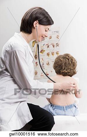 Female doctor examining a baby boy with a stethoscope View Large Photo Image Stock Photograph - Female doctor examining a baby boy with a stethoscope. Fotosearch