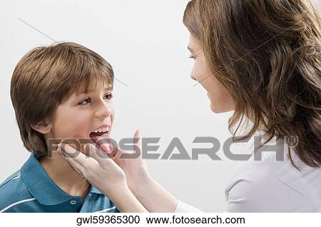 Female doctor examining a boy View Large Photo Image Stock Image - Female doctor examining a boy. Fotosearch