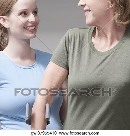 Female doctor helping woman walk with crutches View Large Photo Image Stock Image - Female doctor helping woman walk with crutches. Fotosearch