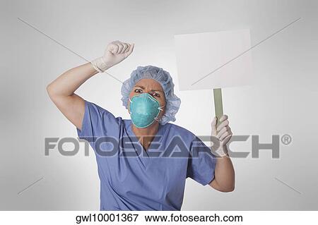 Stock Photo - Female doctor holding a blank placard. Fotosearch