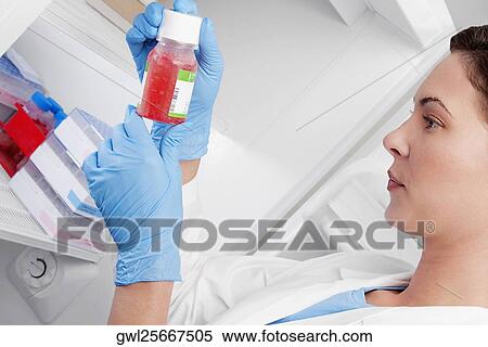 Female doctor holding a bottle of solution in a laboratory View Large Photo Image Stock Photography - Female doctor holding a bottle of solution in a laboratory. Fotosearch
