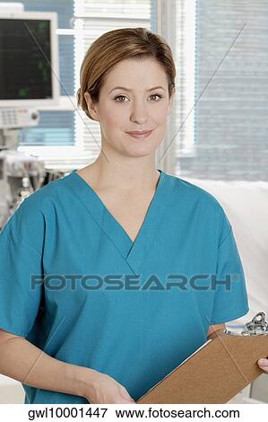 Stock Photo - Female doctor holding a clipboard. Fotosearch