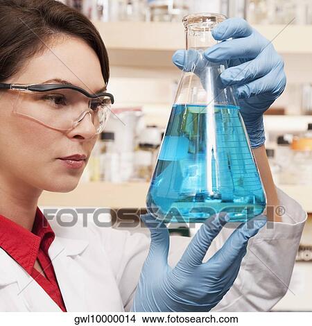 Female doctor holding a conical flask in a laboratory View Large Photo Image Picture - Female doctor holding a conical flask in a laboratory. Fotosearch