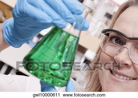 Female doctor holding a conical flask in a laboratory View Large Photo Image Stock Image - Female doctor holding a conical flask in a laboratory. Fotosearch