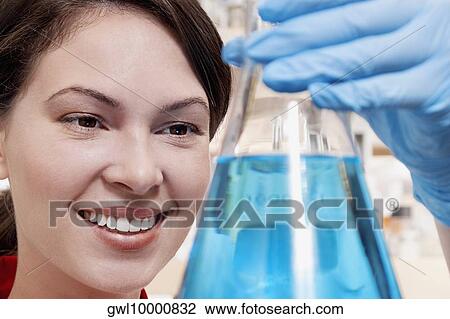 Female doctor holding a conical flask in a laboratory View Large Photo Image Stock Image - Female doctor holding a conical flask in a laboratory. Fotosearch
