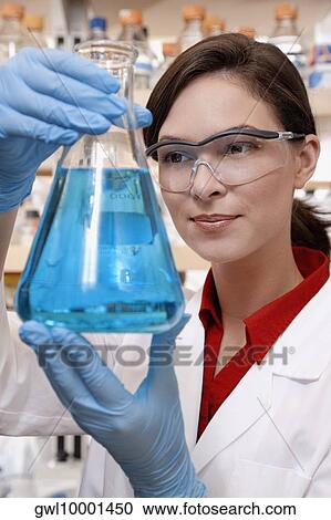 Female doctor holding a conical flask in a laboratory View Large Photo Image Stock Image - Female doctor holding a conical flask in a laboratory. Fotosearch