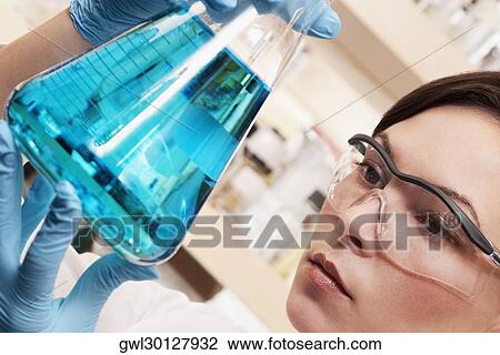 Female doctor holding a conical flask in a laboratory View Large Photo Image Stock Image - Female doctor holding a conical flask in a laboratory. Fotosearch