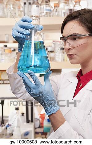 Female doctor holding a conical flask in a laboratory View Large Photo Image Stock Photo - Female doctor holding a conical flask in a laboratory. Fotosearch