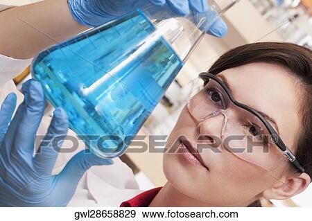 Female doctor holding a conical flask in a laboratory View Large Photo Image Stock Photo - Female doctor holding a conical flask in a laboratory. Fotosearch