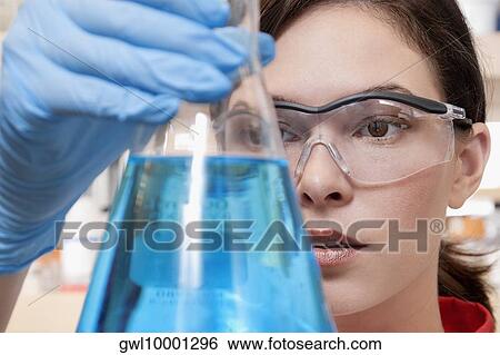 Female doctor holding a conical flask in a laboratory View Large Photo Image Stock Photograph - Female doctor holding a conical flask in a laboratory. Fotosearch