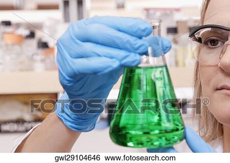 Female doctor holding a conical flask in a laboratory View Large Photo Image Stock Photograph - Female doctor holding a conical flask in a laboratory. Fotosearch