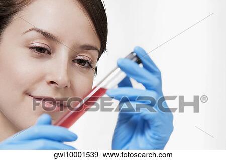 Female doctor holding a medical sample in a laboratory View Large Photo Image Stock Photo - Female doctor holding a medical sample in a laboratory. Fotosearch