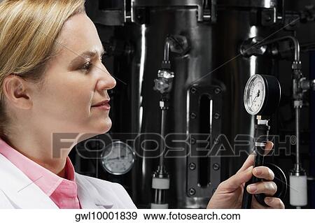Female doctor holding a pressure gauge in a laboratory View Large Photo Image Stock Photo - Female doctor holding a pressure gauge in a laboratory. Fotosearch
