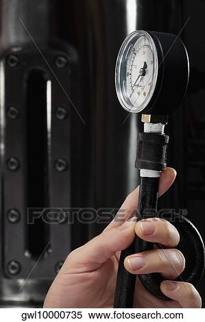 Female doctor holding a pressure gauge in a laboratory View Large Photo Image Stock Photography - Female doctor holding a pressure gauge in a laboratory. Fotosearch