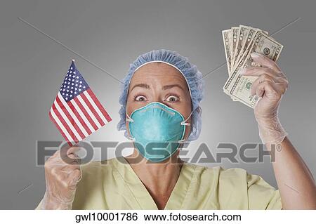 Female doctor holding an American flag and currency notes View Large Photo Image Stock Photograph - Female doctor holding an American flag and currency notes. Fotosearch