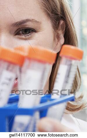 Stock Image - Female doctor holding medical samples in a laboratory. Fotosearch