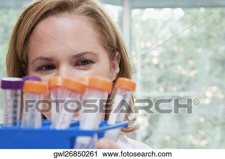 Stock Image - Female doctor holding medical samples in a laboratory. Fotosearch