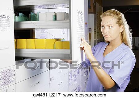 Female doctor in a pharmacy View Large Photo Image Stock Photo - Female doctor in a pharmacy. Fotosearch