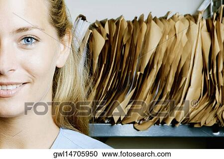 Female doctor in a record room View Large Photo Image Stock Image - Female doctor in a record room. Fotosearch