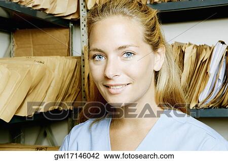 Female doctor in a record room View Large Photo Image Stock Image - Female doctor in a record room. Fotosearch
