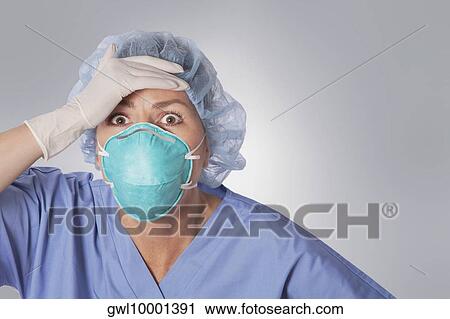 Stock Image - Female doctor looking shocked. Fotosearch
