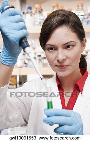 Stock Image - Female doctor researching in a laboratory. Fotosearch