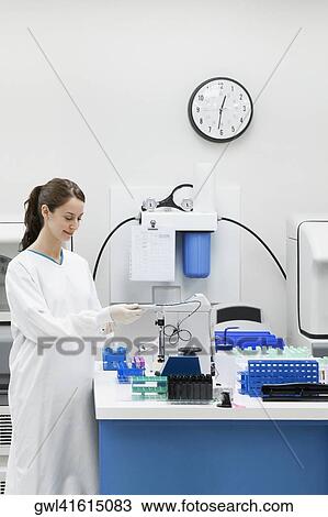 Stock Image - Female doctor researching in a laboratory. Fotosearch