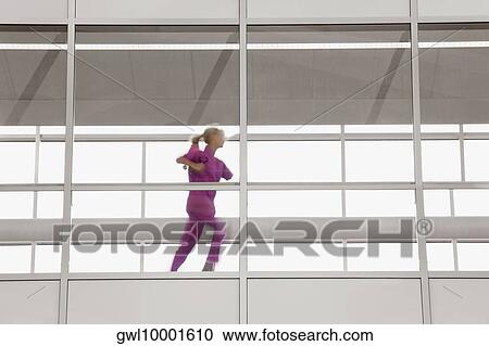 Female doctor running in a hospital corridor View Large Photo Image Stock Image - Female doctor running in a hospital corridor. Fotosearch