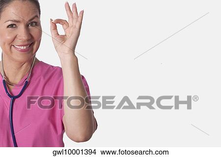 Picture - Female doctor showing ok sign. Fotosearch