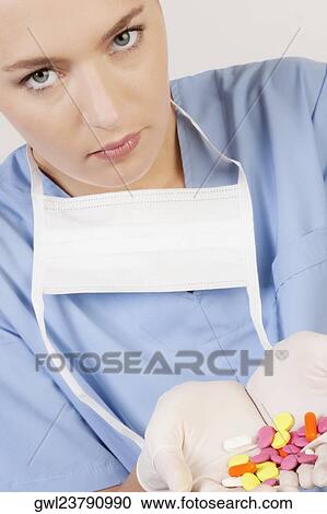 Female doctor showing pills View Large Photo Image Stock Image - Female doctor showing pills. Fotosearch
