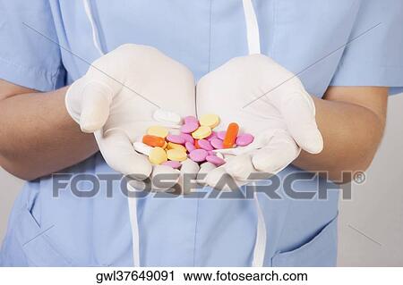 Female doctor showing pills View Large Photo Image Stock Image - Female doctor showing pills. Fotosearch