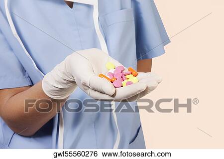 Female doctor showing pills View Large Photo Image Stock Photograph - Female doctor showing pills. Fotosearch