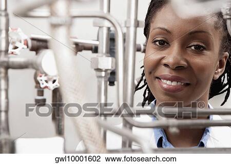 Stock Image - Female doctor smiling in a laboratory. Fotosearch