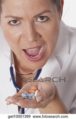 Female doctor taking medicine View Large Photo Image Stock Photo - Female doctor taking medicine. Fotosearch