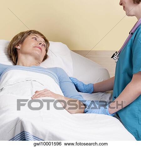 Stock Photograph - Female doctor talking to her patient. Fotosearch
