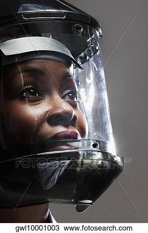 Stock Image - Female doctor wearing a protective gear in a laboratory. Fotosearch