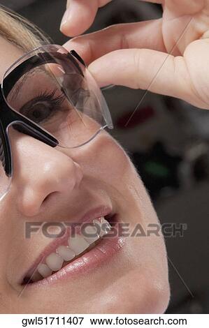 Stock Photo - Female doctor wearing a protective eyewear. Fotosearch