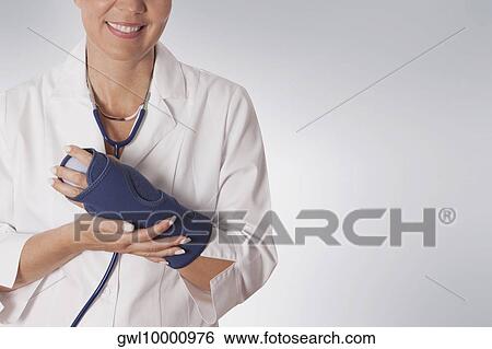 Stock Photograph - Female doctor wearing a wrist brace. Fotosearch