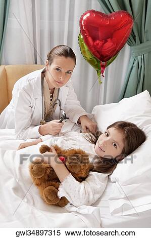Female doctor with a girl in a hospital ward View Large Photo Image Stock Photography - Female doctor with a girl in a hospital ward. Fotosearch