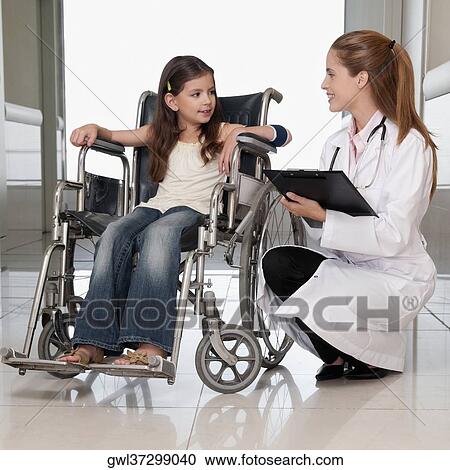 Female doctor with a patient in a wheelchair View Large Photo Image Stock Image - Female doctor with a patient in a wheelchair. Fotosearch