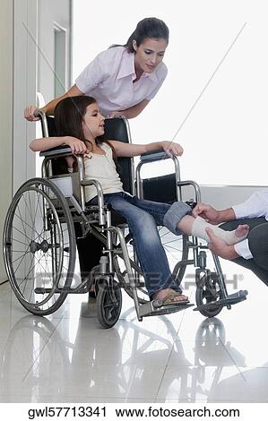 Female doctor with a patient in a wheelchair View Large Photo Image Stock Image - Female doctor with a patient in a wheelchair. Fotosearch
