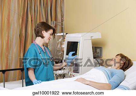 Female doctor working on a cardiac monitor View Large Photo Image Stock Image - Female doctor working on a cardiac monitor. Fotosearch