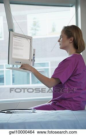 Female doctor working on a computer View Large Photo Image Picture - Female doctor working on a computer. Fotosearch