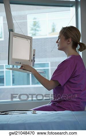 Female doctor working on a computer View Large Photo Image Stock Image - Female doctor working on a computer. Fotosearch