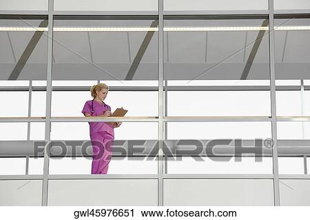 Female doctor writing on a clipboard View Large Photo Image Stock Image - Female doctor writing on a clipboard. Fotosearch